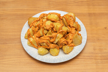 Patatas bravas with a very runny sauce that soaks the potatoes well and collects at the bottom of the plate, perfect for dipping bread.