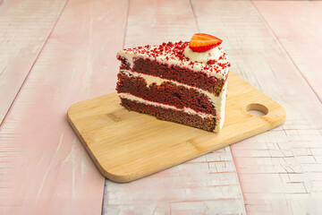 the perfect portion of moist, velvety red sponge, with its characteristic dark edges, accompanied by a rosette of frosting and a mint leaf.