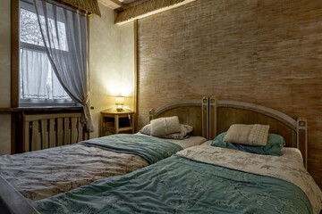 Cozy rustic bedroom interior with twin beds and warm lighting