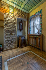 Rustic hallway detail with antique clock and mosaic window