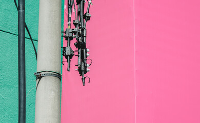 Minimalist Urban Infrastructure with Vibrant Pink Copy Space. Industrial Utility Pole and Wires against Teal and Magenta Background. Modern Tech Connectivity Concept.