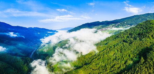 Aerial view of beautiful green forest and mountain with white clouds natural landscape in Guilin, China.