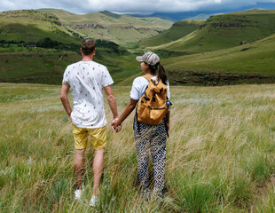 Couple exploring the breathtaking landscapes of Drakensberg Giant Castle in South Africa