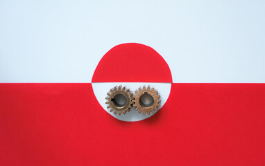 Minimalistic image of metal gears on the flag of Greenland. Relations concept between countries. Geopolitical interests in the Arctic region. Abstract political concept.