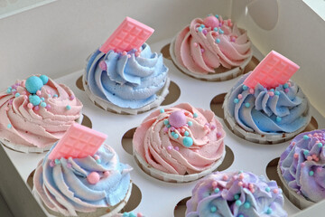 Colorful cupcakes with frosting and sprinkles perfect for festive celebration. Freshly baked cupcake box with creamy purple frosting. Decorated cakes. Sweet Dessert Preparation. Pastry small business