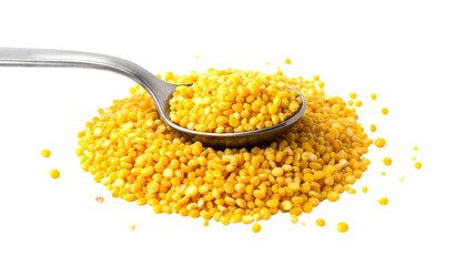 Close-up of split, yellow pulses piled with a spoon. The pulses are scattered with a dark background