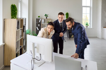 Business team at office meeting strategy discussion. Focused planning and analysis support collaboration at a computer as colleagues review data and align goals. Team at work on strategy goals.