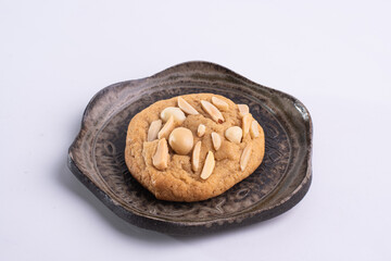 soft cookies with almond macadamia and chocolate on a table and plate