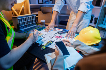 A diverse team of professionals shares ideas about architectural layouts and structural concepts, focusing on teamwork, creativity, and precision in modern engineering design discussions.