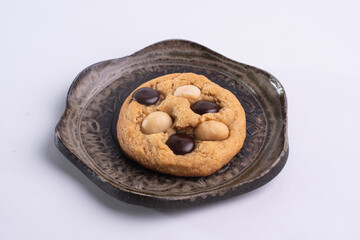 soft cookies with almond macadamia and chocolate on a table and plate