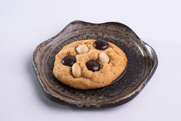 soft cookies with almond macadamia and chocolate on a table and plate