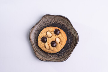 soft cookies with almond macadamia and chocolate on a table and plate