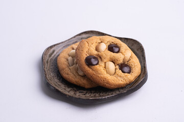 soft cookies with almond macadamia and chocolate on a table and plate