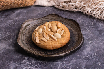 soft cookies with almond macadamia and chocolate on a table and plate