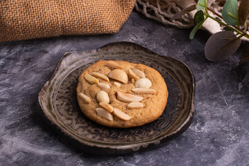 soft cookies with almond macadamia and chocolate on a table and plate