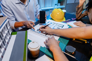 Engineers and architects analyze construction models and discuss project strategies, combining technical knowledge and creative ideas to achieve successful architectural design solutions.