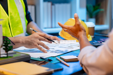 A team of architects and engineers coordinates on an architectural project, reviewing design concepts and technical plans to ensure efficiency and creativity in modern construction development.