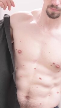 Headless man put on black short sleeve shirt