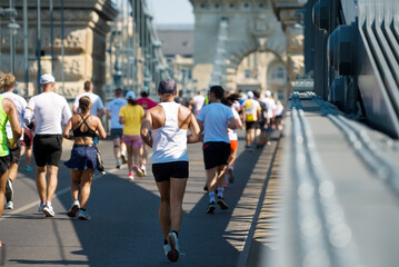 Marathon runners on a bridge