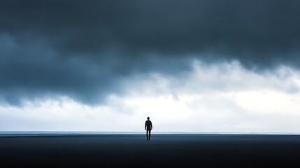 Silhouette of solitary figure standing beneath ominous storm clouds horizon