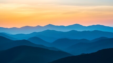 Fototapeta premium Silhouetted blue mountains at sunset scenic landscape and natural beauty