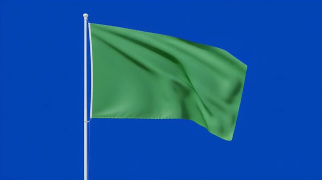 Green flag waving dynamically against clear a plain blue screen background&nbsp;for eco friendly, sustainable development campaign video footage
