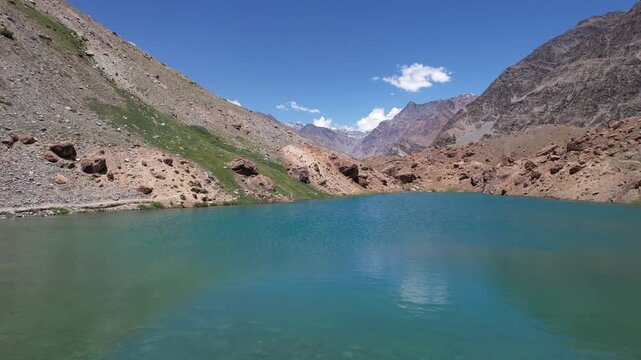 Aerial view of Deepak Tal Lake surrounded by barren mountains in Ladakh, India