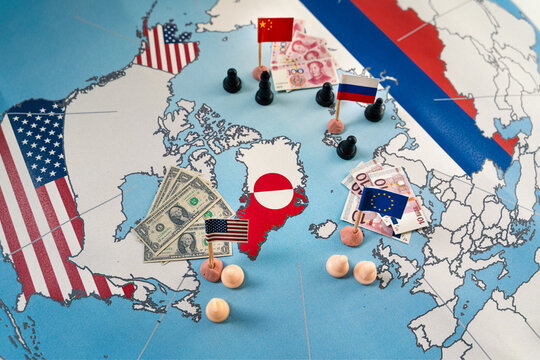 Strategic map showing Greenland with country flags, chess pawns, and international currencies, illustrating geopolitical competition and economic influence from major global powers