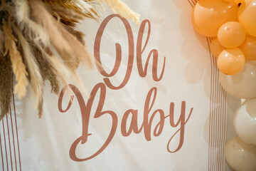 Celebration decoration with Oh Baby sign and balloon display for a special event