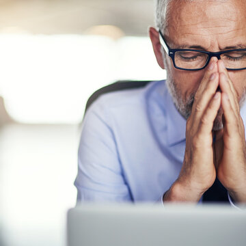 Stress, prayer and mature man in office with laptop, anxiety and brainstorming for investment business debt. Thinking, ideas and businessman with faith, fear and bankruptcy at risk management agency