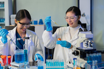 Scientists conducting research in a biotechnology lab, using pipettes and test tubes for medical and chemical experiments. Innovation in chemistry, healthcare, and medicine.