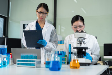Scientists conducting research in a biotechnology lab, using pipettes and test tubes for medical and chemical experiments. Innovation in chemistry, healthcare, and medicine.