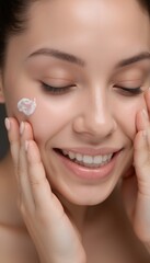 A close-up shot of a woman with white skincare cream on her cheek.