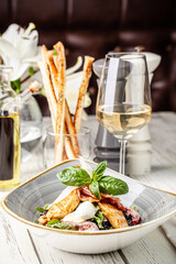 Grilled chicken salad with wine restaurant table