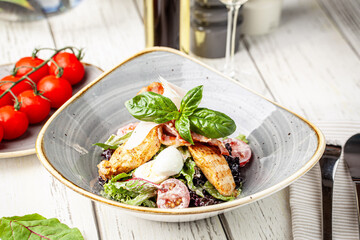 Grilled chicken salad with basil and cheese