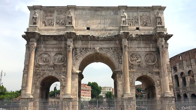 Arch of Constantine monumental triumphal gateway rises in Rome Italy representing power and victory symbolism. Ancient marble structure displays carved panels, pillars, and imperial artistic heritage.