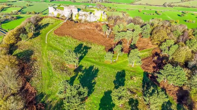 An aerial view panning up towards Beeston castle and surrounding countryside Chirk, Wales