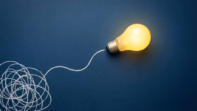 Untangling Ideas Bright Lightbulb Illuminating the Path Through Confusion on Dark Background