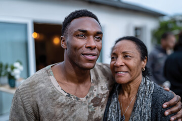 A close-up capture of a soldier with his mother in a warm embrace, revealing deep emotional bonds, love, and connection during a heartfelt moment in a natural setting.
