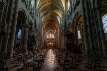 Interior view of the nave of Cathedral Saint-Étienne in Sens, featuring the central aisle, vaulted ceilings, arches, and stained glass, highlighting Gothic architecture and historic grandeur.   © Tim van den Brink