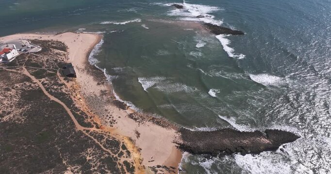 Drone aerial of dramatic river mouth and sand spit on Alentejo Coast Portugal with Atlantic breakers, Rota Vicentina Fishermen's Trail