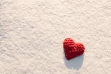 Valentine's Day greeting card with free space for text, red heart on white snow, love winter background