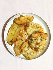 Gorengan, a traditional Indonesian street food consisting of fried bananas and bakwan (fried...
