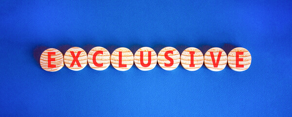 Exclusive symbol. Concept words Exclusive on beautiful wooden circles. Beautiful blue background. Business support exclusive concept. Copy space.