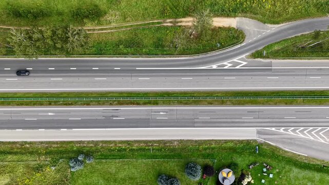 Top down aerial view tracking highway traffic with visible overtaking maneuvers