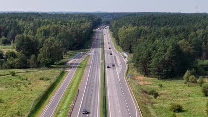 Aerial view descending over A1 highway with exit ramp and parallel service road