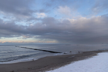 Wooden wave breaker at Koserow beach on Usedom Island in winter
