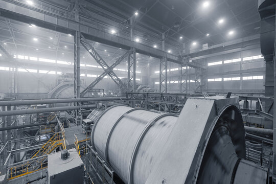 Industrial ball mill grinds ore at mining and concentrating plant. Concentration factory for copper, gold, magnetite concentrate.