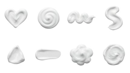 White cosmetic cream set including heart, spiral, wave, and smear shapes. Skincare product texture and beauty lotion collection.
