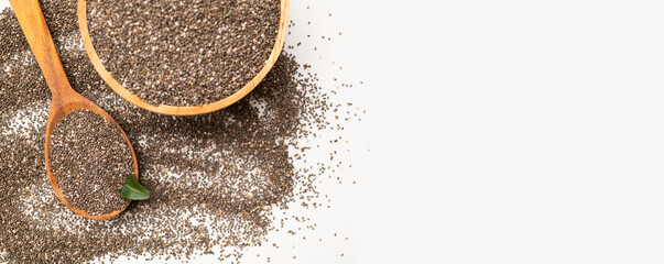 Close-up of chia seeds in wooden spoon and a bowl. Superfood, organic, healthy dry seeds for meals, breakfast, and desserts. Rich in omega-3, protein and protein. Food background